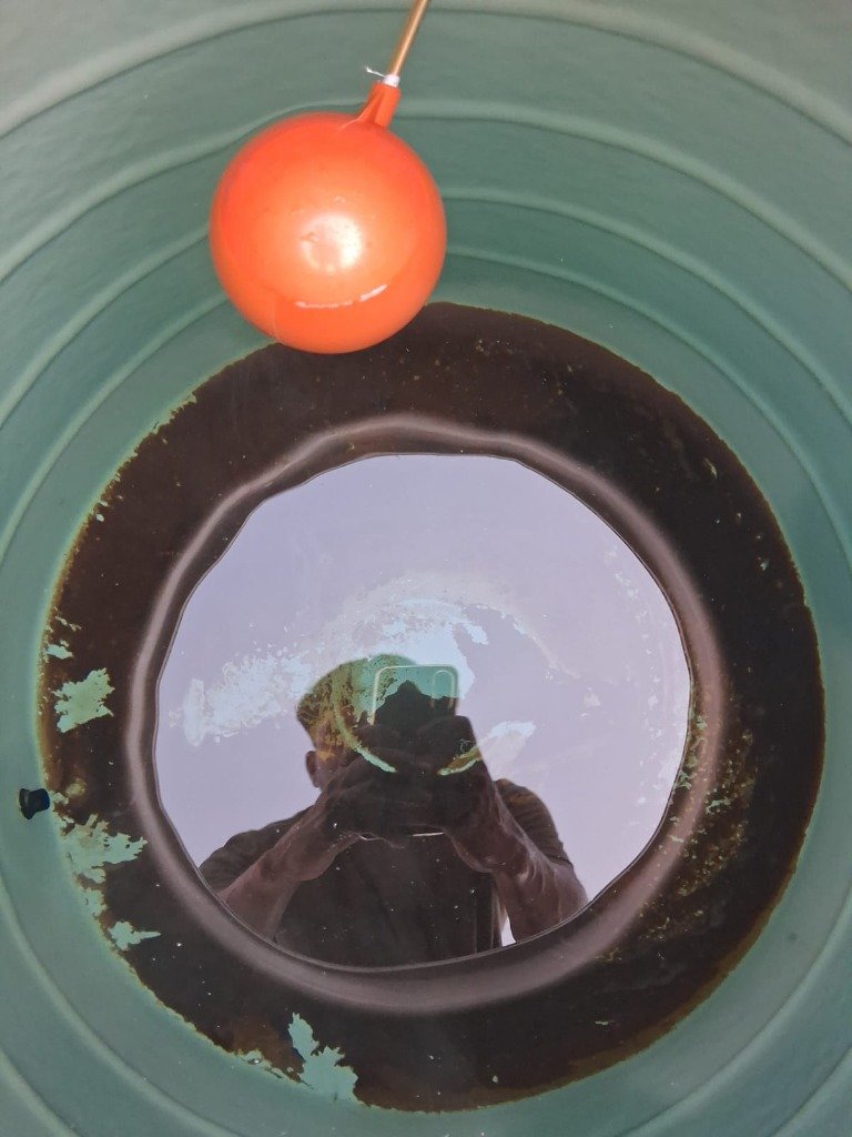Dirty Water Tank with Black Sludge Before Cleaning